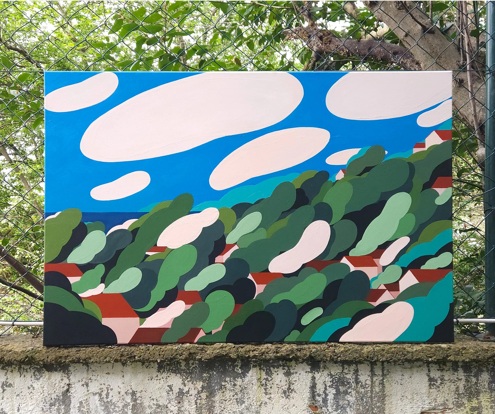 Plomari Attack — acrylic painting of a hillside of rounded green trees and red rooftops under a blue sky with soft pink clouds
